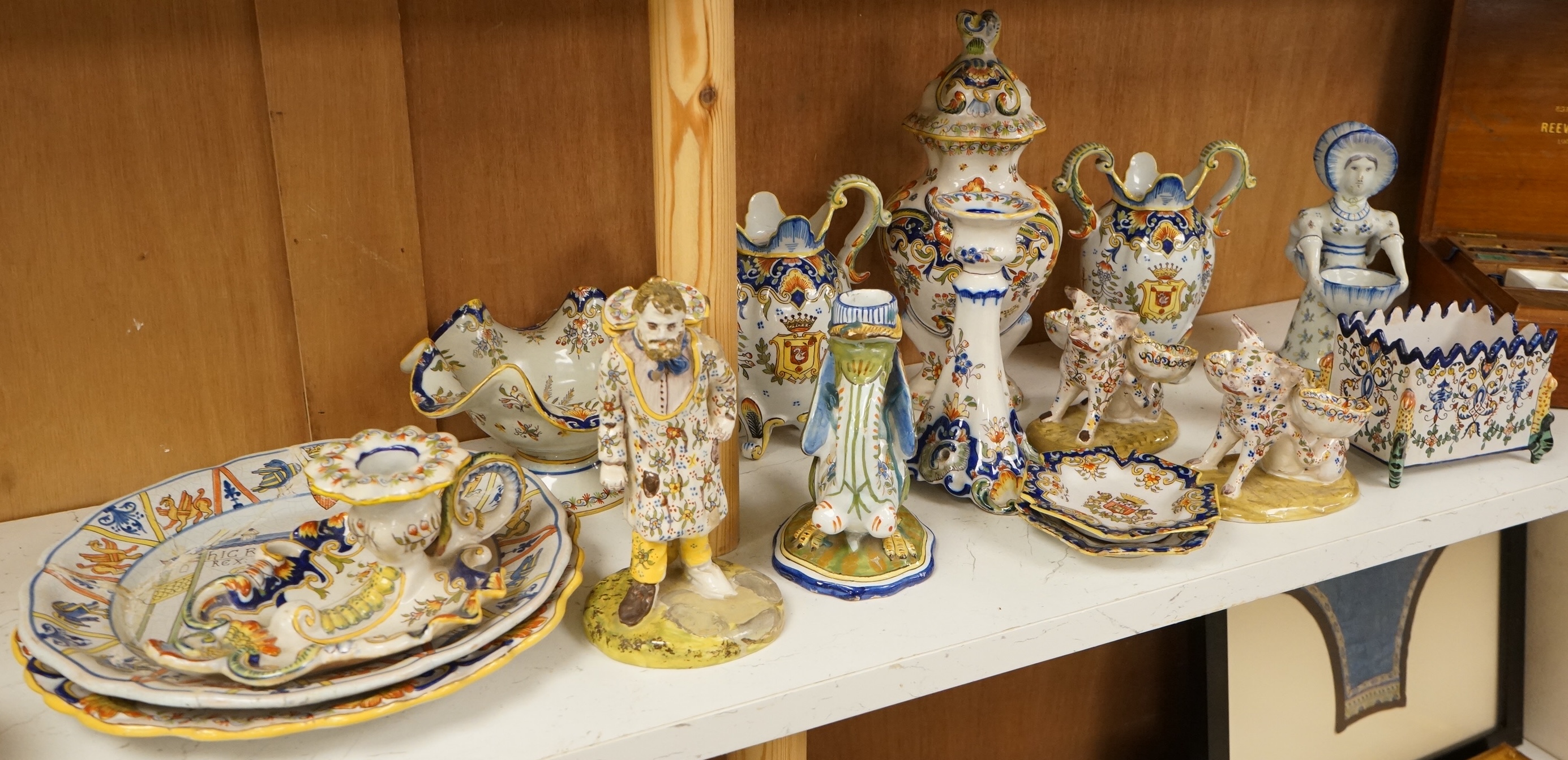A collection of early 20th century French faience pieces to include a pair of salts in the form of pigs and candlesticks, largest 27cm high
